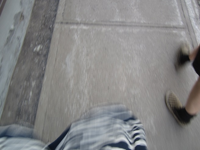 photo of legs walking on sidewalk